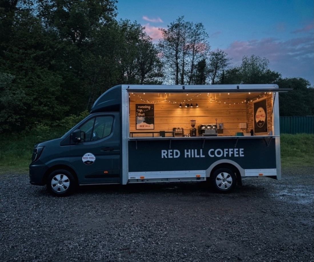 The Red Hill Coffee Roadhouse mobile coffee bar lit at dusk
