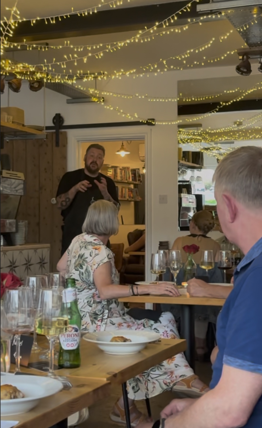 Tom speaking to Supper Club guests over dinner beneath the fairy lights at Red Hill