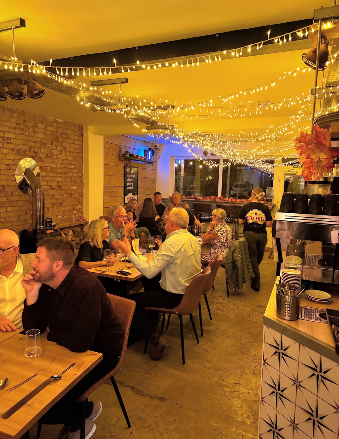 Guests sharing dinner beneath the fairy lights at Red Hill’s October 2026 Supper Club